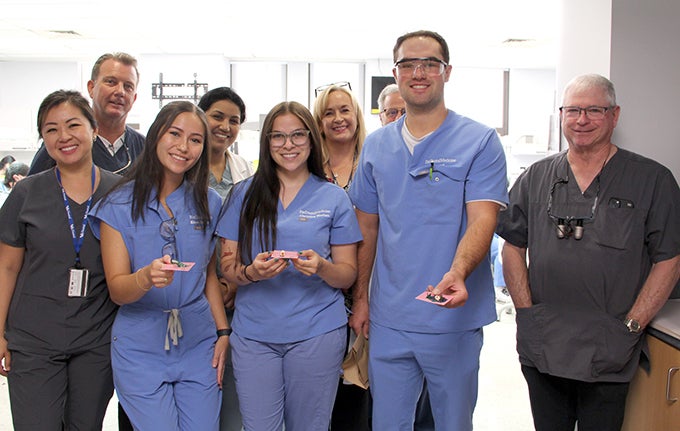 Faculty and Students in the Anatomy and Morphology course holding tiny wax sculptures