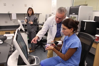 Photo of Dr. Bob Nerone instructing student in digital lab
