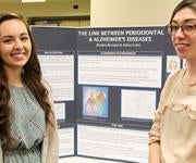  Students in front of research presentation